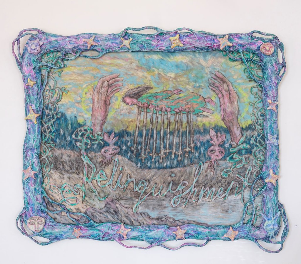 Blue papier mache frame covered in tendrils, stars and faces; within it a colourful drawing of two hands and a woman being impaled by swords, over the word 'Relinquishment' in cursive script.