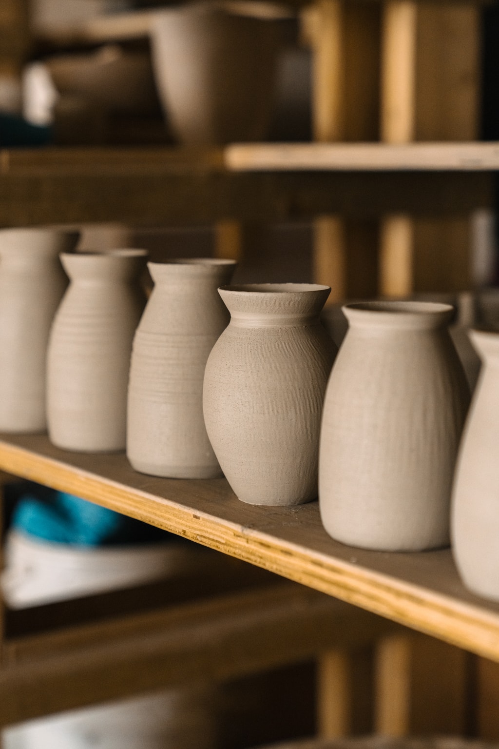Row of unfired clay vases.
