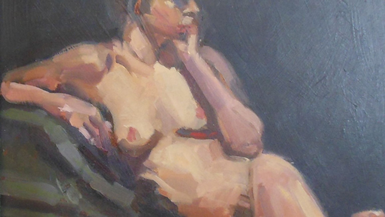 Nude study of a woman reclining on a green sofa.