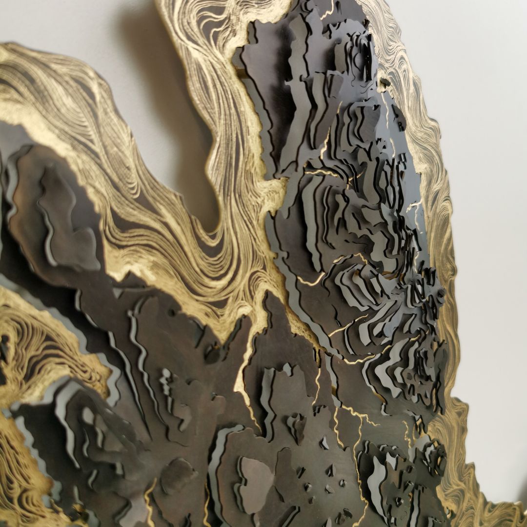 Close up of a brass and gold contour map sculpture by Holly Clifford.