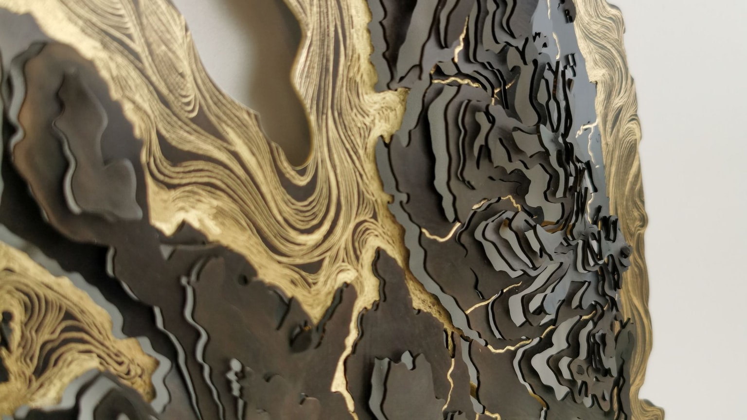 Close up of a brass and gold contour map sculpture by Holly Clifford.