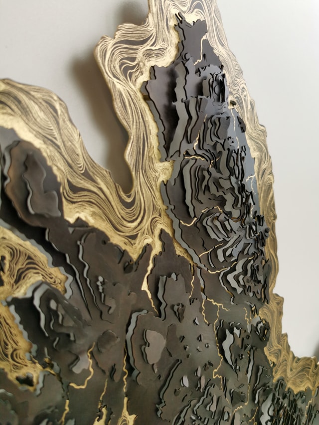 Close up of a brass and gold contour map sculpture by Holly Clifford.