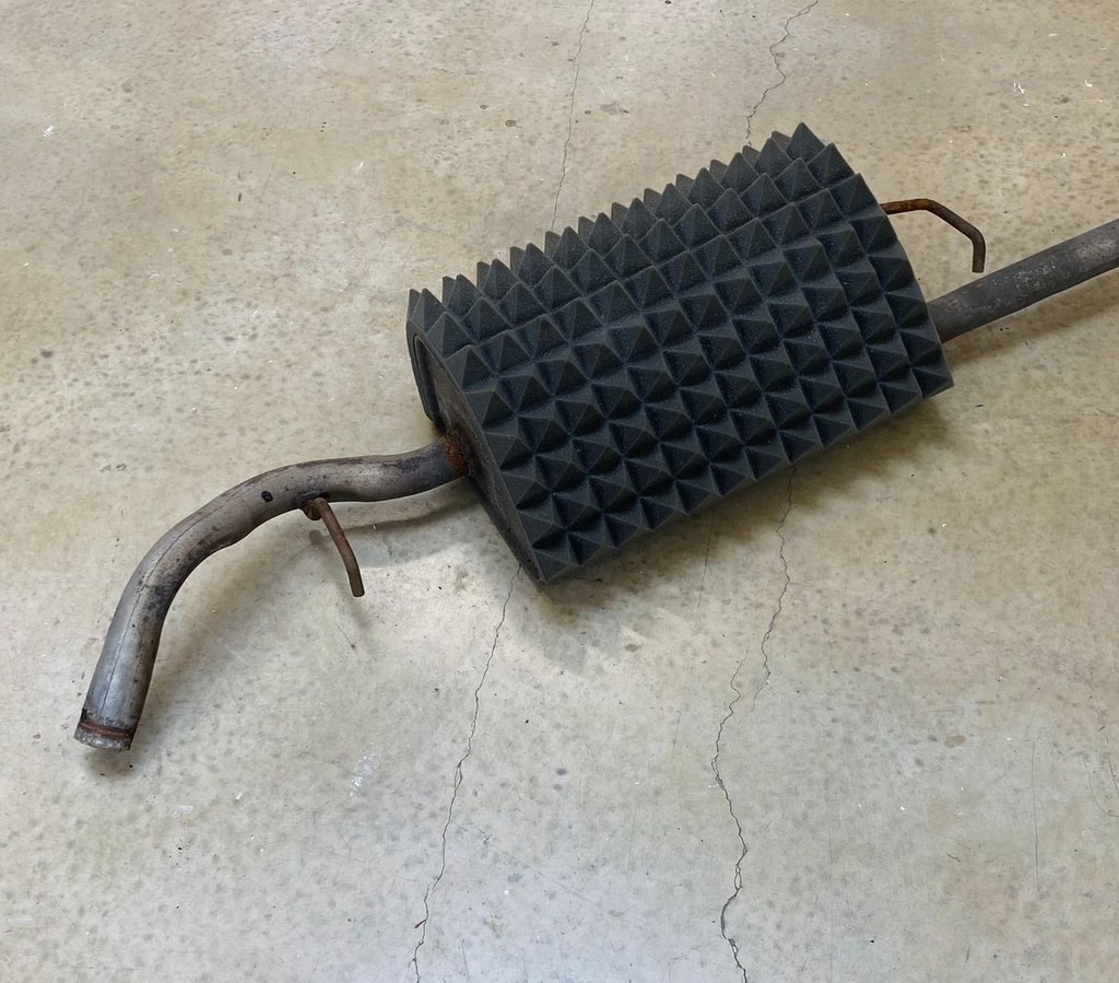 A sculpture made from an old engine wrapped in black spiky packaging foam, by Mary Farrall.