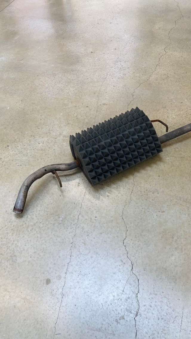A sculpture made from an old engine wrapped in black spiky packaging foam, by Mary Farrall.