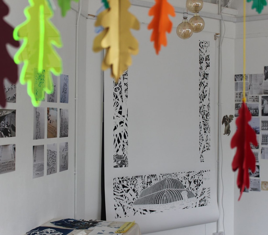 Unfinished papercut artwork by Bethan Maddock with perspex oak leaves in forground.