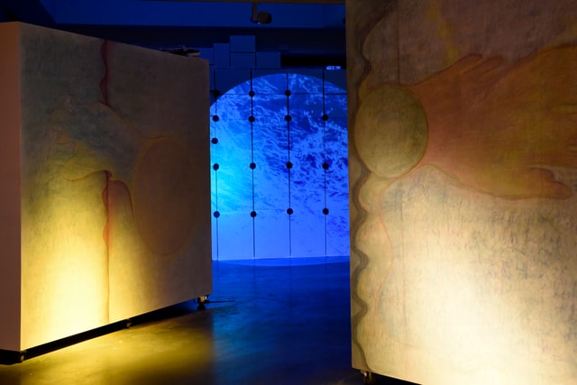 Installation by Emma Bolland, featuring abstract wall drawings and a projection of water.