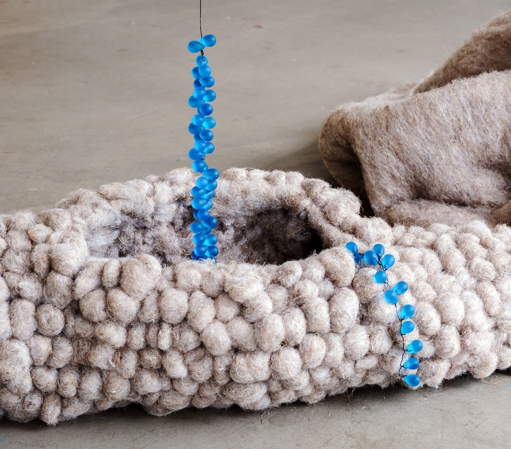 Sculpture by Lucie Kordacova using blue beads and woven material.